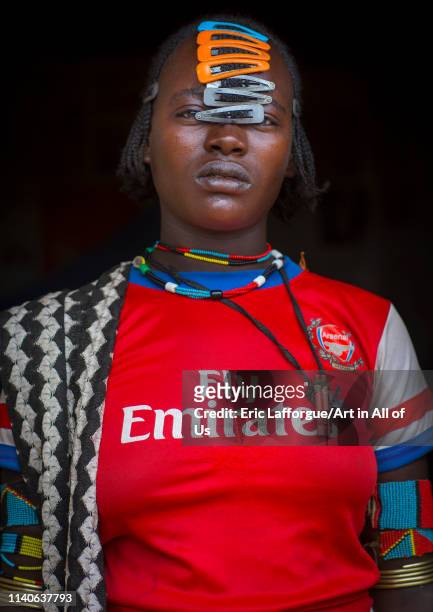 Hamer tribe woman with an arsenal football shirt, Key afer, Omo valley, Ethiopia on January 2, 2014 in Key Afer, Ethiopia.