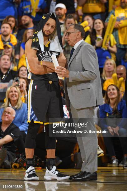 Stephen Curry of the Golden State Warriors talks with assistant coach Ron Adams during the game against the Houston Rockets during Game Two of the...