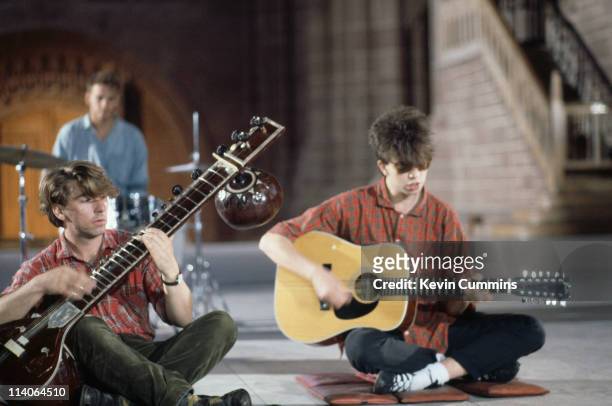Ian McCulloch, Will Sargeant and Pete De Freitas of British band Echo And The Bunnymen perform seated circa 1985.