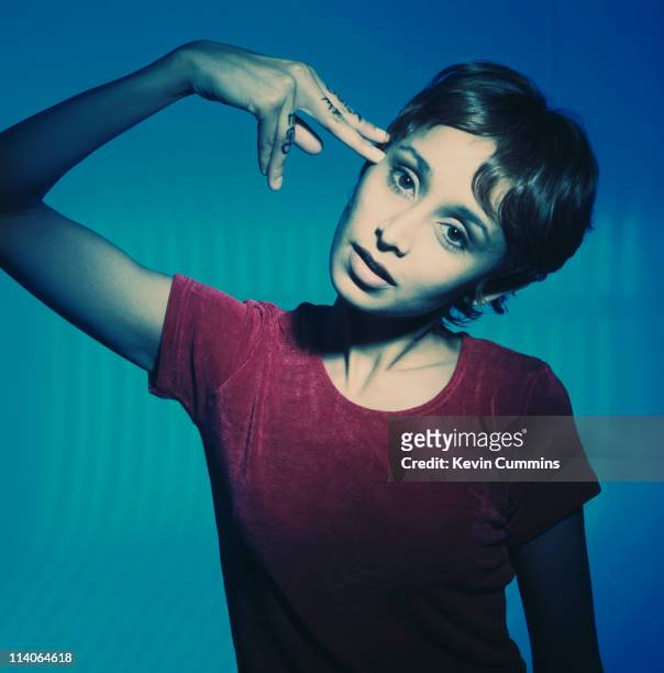 Sonya Madan, singer with the Britpop band Echobelly, mimics holding a gun to her head with her hand circa 1998.