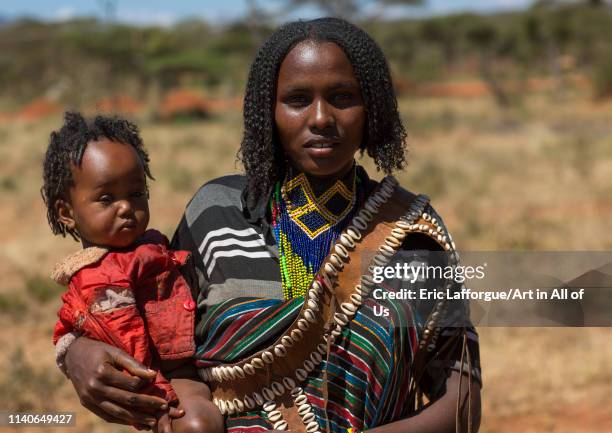 Borana tribe mother carrying her baby, Yabelo, Ethiopia on January 7, 2014 in Yabelo, Ethiopia.