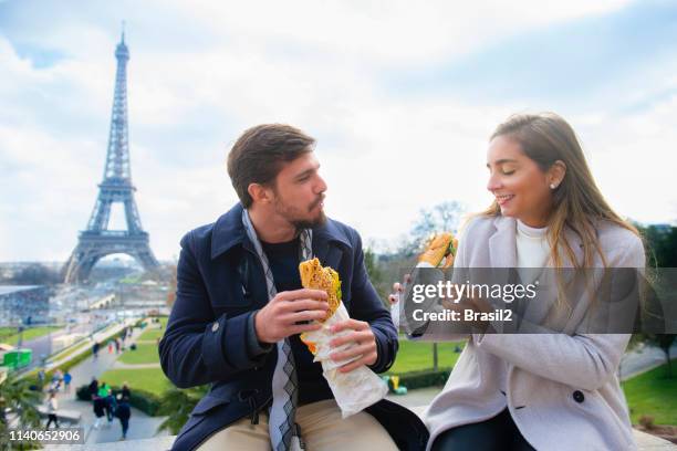 picknick in de voorkant van de eiffel toren - couple paris tour eiffel trocadero stockfoto's en -beelden