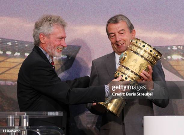 Paul Breitner , representative of FC Bayern Muenchen hands over the cup to Wolfgang Niersbach , general secretary of the DFB during the DFB cup...