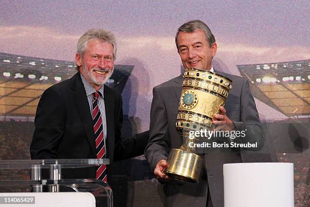 Paul Breitner , representative of FC Bayern Muenchen hands over the cup to Wolfgang Niersbach , general secretary of the DFB during the DFB cup...