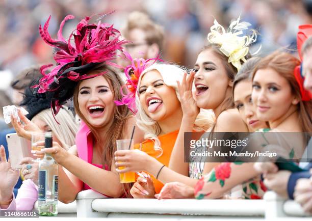 Racegoers watch the racing on day 2 'Ladies Day' of The Randox Health Grand National Festival at Aintree Racecourse on April 5, 2019 in Liverpool,...