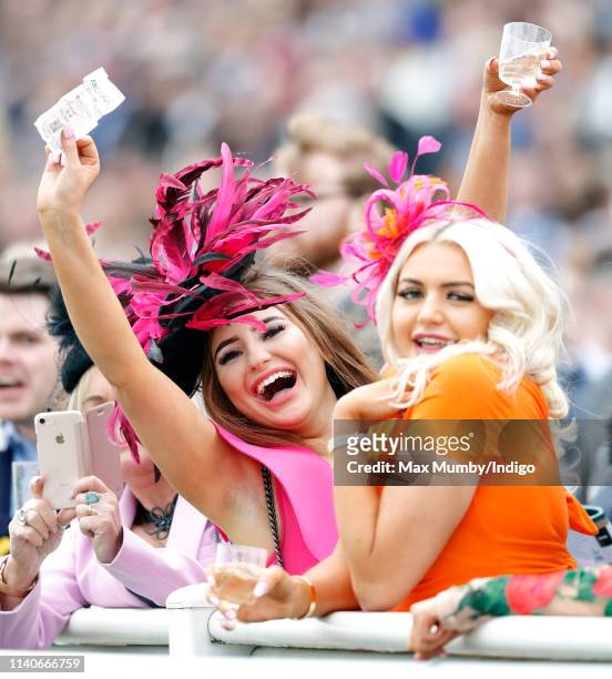 Racegoers watch the racing on day 2 'Ladies Day' of The Randox Health Grand National Festival at Aintree Racecourse on April 5, 2019 in Liverpool,...