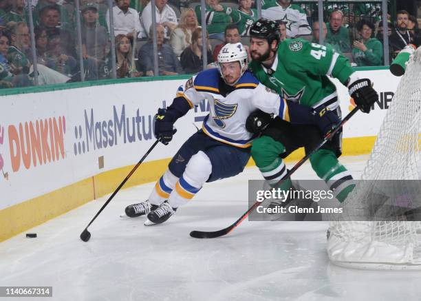 Tyler Bozak of the St. Louis Blues tries to keep the puck away against Roman Polak of the Dallas Stars in Game Four of the Western Conference Second...