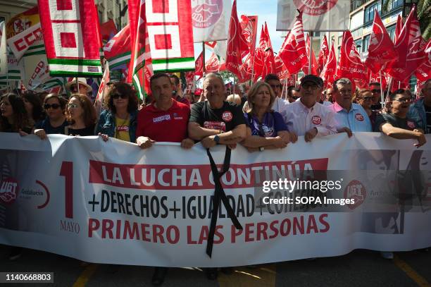 Protesters are seen holding a banner and flags during the Labour Day demonstration. Thousands of people called by the General Workers Union , and the...