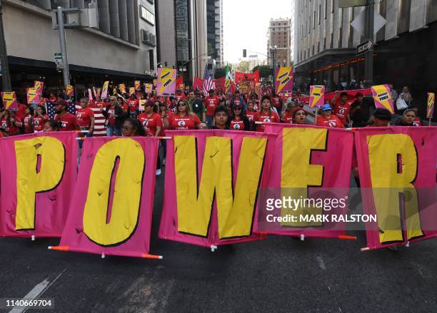 Union members, activists and their supporters march through the city during their annual May Day procession in support of workers' rights and...