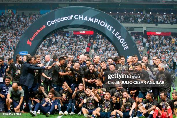 Mexico's Monterrey team players celebrate holding the trophy after winning the CONCACAF Champions League by defeating Tigres at the BBVA Bancomer...