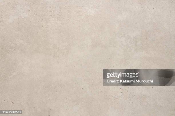 concrete wall texture background - beige stock-fotos und bilder