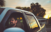 Bearded man in a truck going for a drive at dusk