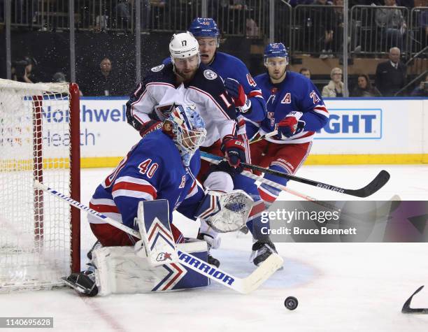 Brandon Dubinsky of the Columbus Blue Jackets is stopped by Alexandar Georgiev of the New York Rangers at Madison Square Garden on April 05, 2019 in...