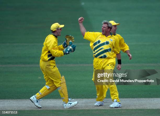 Australian bowler Shane Warne celebrates with Adam Gilchrist and Darren Lehmann after one of his 4 wickets in the World Cup Final between Australia...