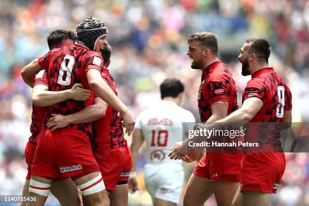 Cai Devine and Wales celebrate after beating USA on day two of the Cathay Pacific/HSBC Hong Kong Sevens at the Hong Kong Stadium on April 06, 2019 in...