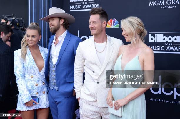 Brian Kelley and Tyler Hubbard of Florida Georgia line and wives Hayley Stommel and Brittney Marie Cole attend the 2019 Billboard Music Awards at the...