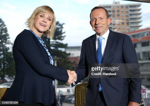 In this handout image provided by News Corp Australia, Warringah candidates Tony Abbott and Zali Steggall shake hands at the beginning of the Sky...