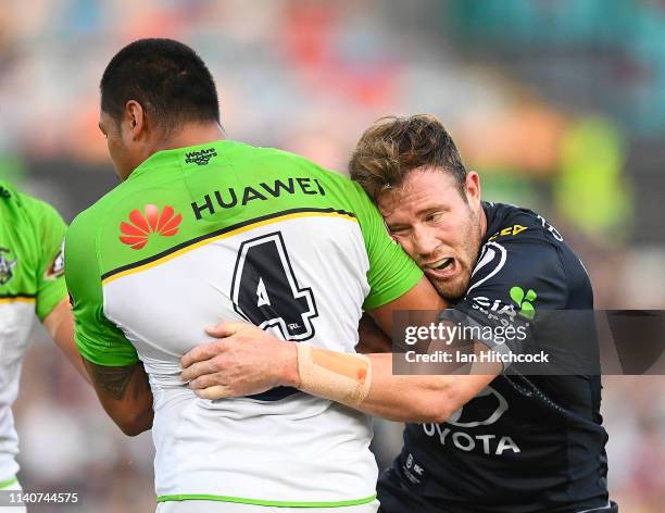 Joey Leilua of the Raiders is tackled by Gavin Cooper of the Cowboys during the round four NRL match between the North Queensland Cowboys and the...