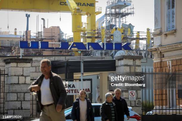 Striking workers exit through the main gate at the Uljanik d.d. Shipyard in Pula, Croatia, on Wednesday, April 17, 2019. The threatened demise of...