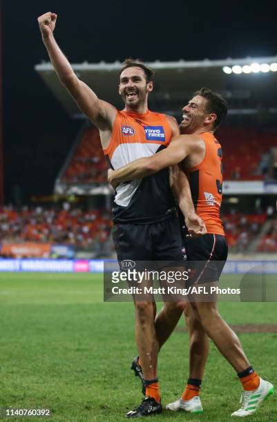 Jeremy Finlayson of the Giants celebrates with Stephen Coniglio after kicking a goal during the round three AFL match between the Greater Western...