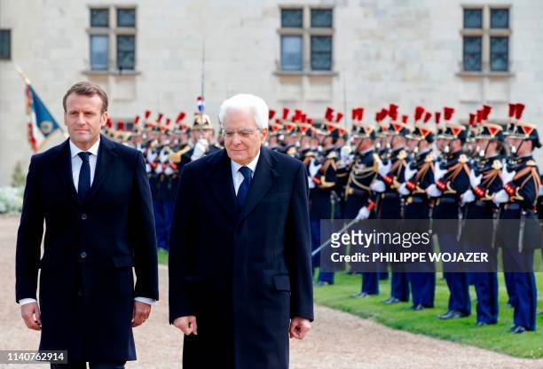 French President Emmanuel Macron and Italian President Sergio Mattarella walk past French Republican guards prior to a ceremony to commemorate the...