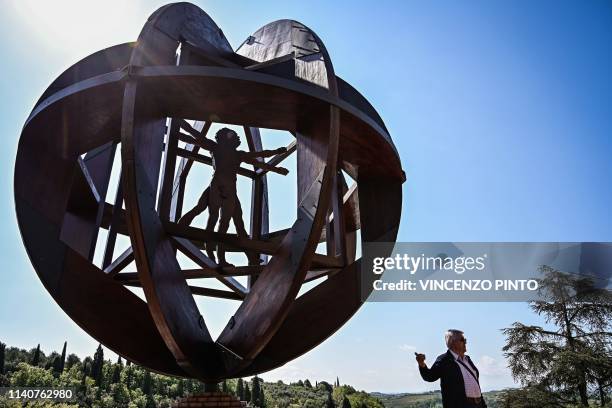 Visitor poses by a wooden representation of the Vitruvian Man , a circa 1490 drawing by Leonardo Da Vinci in which he represented a man with the...