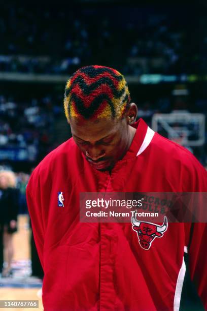 Dennis Rodman of the Chicago Bulls stands for the National Anthem prior to a game against the New Jersey Nets before Game Three of Round One of the...