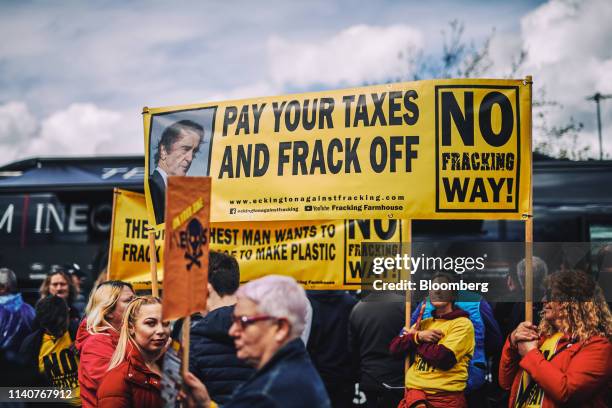 Demonstrators hold an anti-fracking banner featuring an image of Jim Ratcliffe, chairman and founder of Ineos Group Holdings Plc, ahead of the debut...