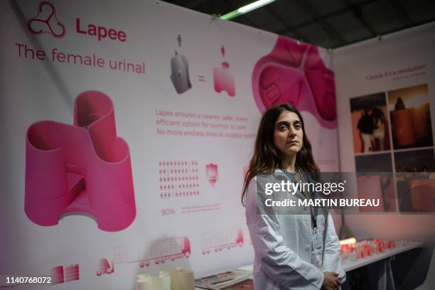 French inventor and Lepine contest participant Gina Perier who created a women's urinal poses for a photo during the Foire de Paris in Paris, on May...