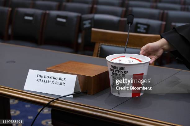 Person places an empty KFC chicken bucket next to the name card for William Barr, U.S. Attorney general, during a House Judiciary Committee hearing...