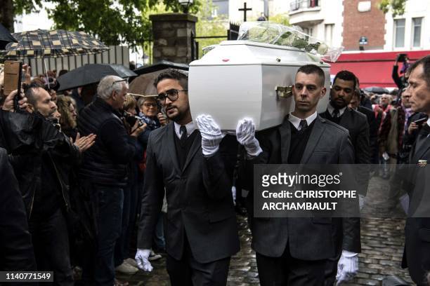 Pallbearers carry the coffin of the late French singer Herve Forneri aka Dick Rivers ahead of his funeral ceremony at the Saint-Pierre de Montmartre...