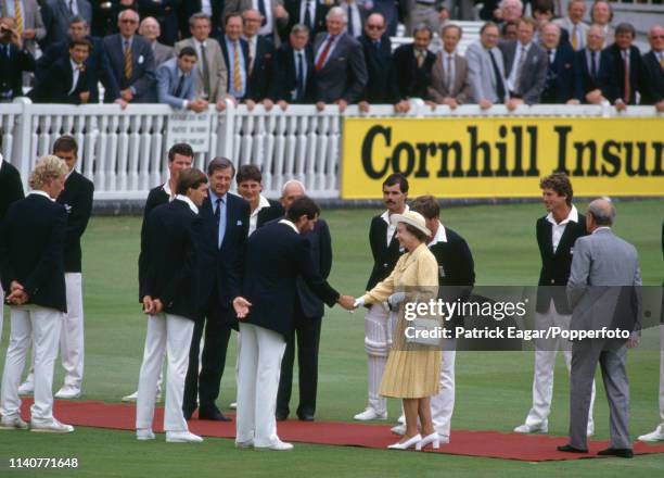 The Queen is introduced to Graham Gooch of England and the rest of the team by England captain Mike Gatting during the 1st Test match between England...