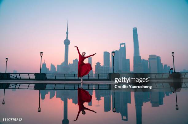 free ballet woman dancing at shanghai bund in the morning,china - urban ballet stockfoto's en -beelden