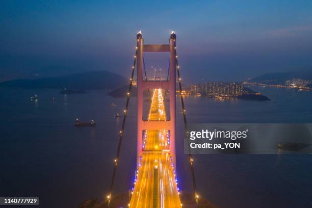 tsing ma bridge aerial scene in night time, ma wan, hong kong - tsing ma bridge stock-fotos und bilder