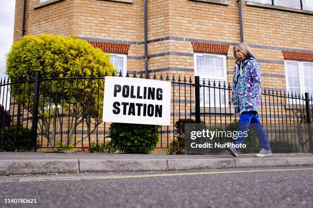 Woman walks past a sign for a polling station in the New Forest District Council town of New Milton in Hampshire, England, on May 2, 2019. Local...