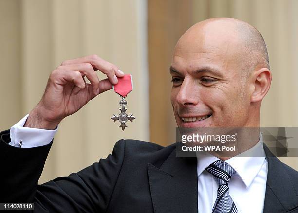 World Cup Referee Howard Webb poses in the Quadrangle of Buckingham Palace after being presented with a Member of the British Empire medal by Prince...