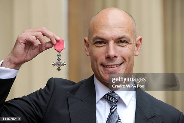 World Cup Referee Howard Webb poses in the Quadrangle of Buckingham Palace after being presented with a Member of the British Empire medal by Prince...