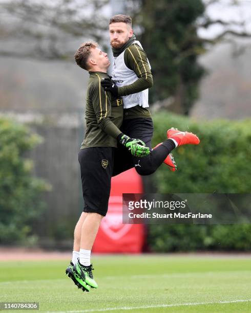 Bernd Leno and Shkodran Mustafi of Arsenal jump up together during a training session at London Colney on April 06, 2019 in St Albans, England.