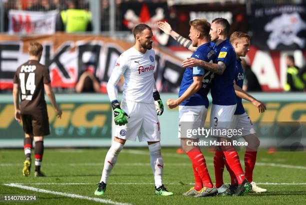 Kenneth Kronholm of Holsein Kiel celebrates with his team mates after making a save during the Second Bundesliga match between Holstein Kiel v FC St....