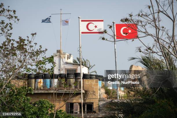 On 25 April 2019, the Greek and Cypriot Republic flags are visible across the separating green line from the Turkish and Turkish Cypriot flags in...