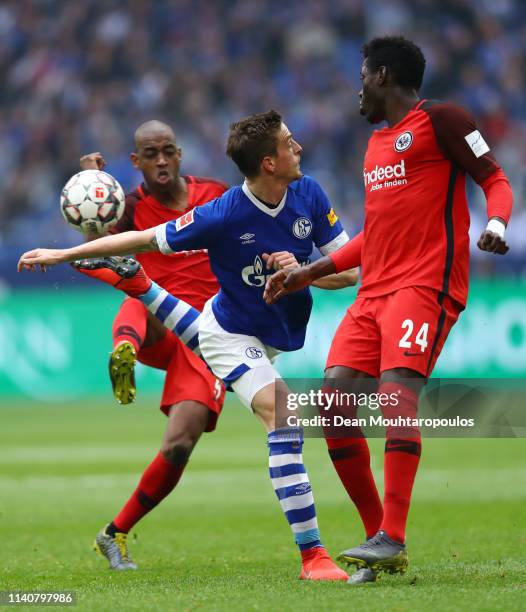 Bastian Oczipka of FC halke 04 controls the ball as he is challenged by Danny Da Costa of Eintracht Frankfurt and Gelson Fernandes of Eintracht...