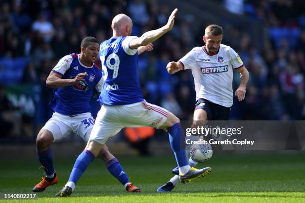 Gary O'Neil of Bolton gets past James Collins of Ipswich Town during the Sky Bet Championship match between Bolton Wanderers and Ipswich Town at...