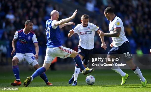 Gary O'Neil of Bolton gets past James Collins of Ipswich Town during the Sky Bet Championship match between Bolton Wanderers and Ipswich Town at...