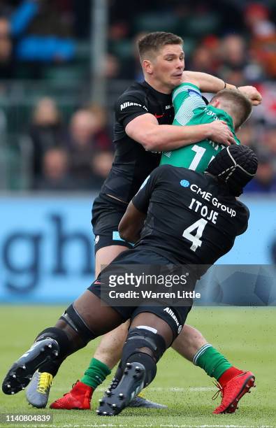 Alex Tait of Newcastle Falcons is tackled by Owen Farrell, Saracens Captain and Maro Itoje during the Gallagher Premiership Rugby match between...