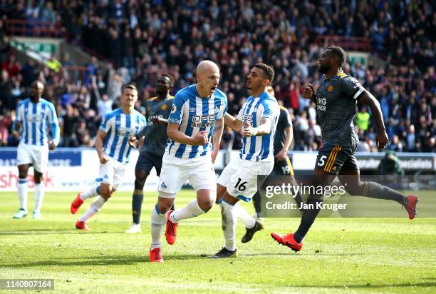 Aaron Mooy of Huddersfield Town celebrates after scoring his team's first goal from the penalty spot during the Premier League match between...