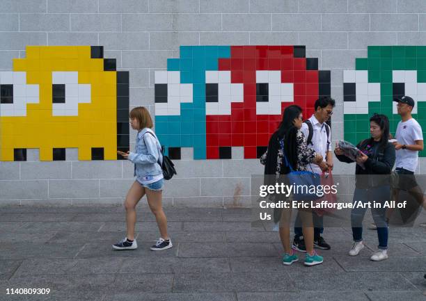 Invader pac-man mosaics on a wall in the street, Kowloon, Hong Kong, China on November 5, 2017 in Hong Kong, China.