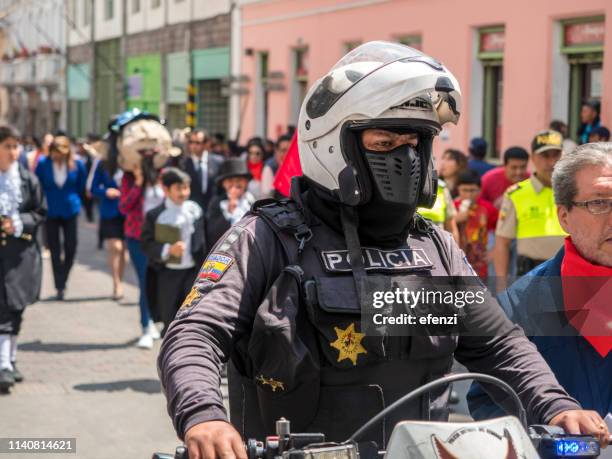 policeman securing the municipal schools parade in quito - carnival in ecuador stock pictures, royalty-free photos & images