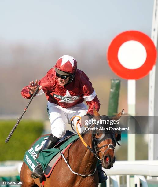 Davy Russell celebrates as he rides Tiger Roll to win The Randox Health Grand National on Grand National Day at Aintree Racecourse on April 06, 2019...