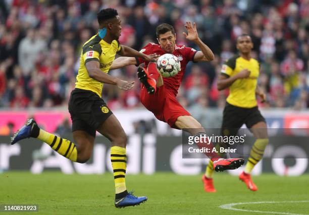 Robert Lewandowski of FC Bayern Muenchen scores his first goal against Dan-Axel Zagadou of Borussia Dortmund during the Bundesliga match between FC...