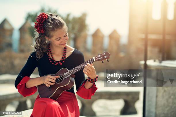 spanish girl playing guitar - folk music stock pictures, royalty-free photos & images